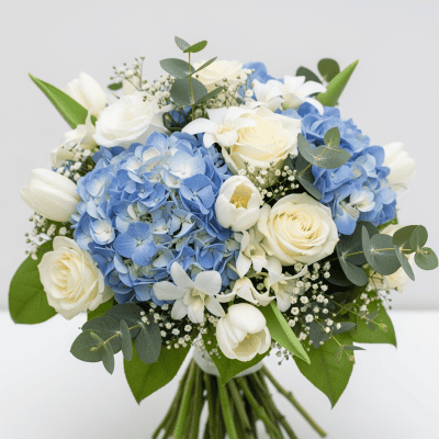 White and blue floral bouquet with roses, hydrangeas, tulips, baby's breath, and eucalyptus leaves for elegant flower delivery in Las Vegas.