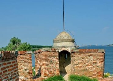 The weathered stone wall of the ancient castle stands tall, showcasing its rich history and grandeur.