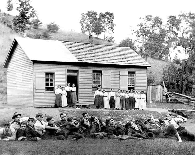 Old rural schoolhouse in Hardy County, West Virginia, surrounded by children and nature scenes.