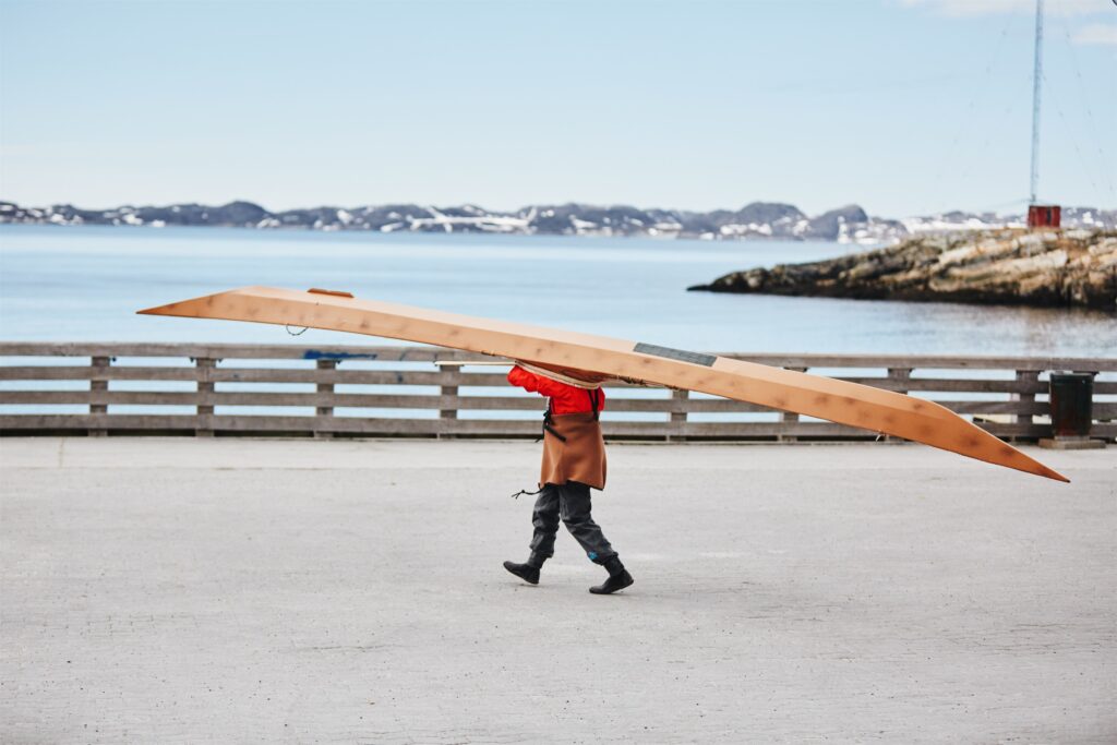 Kayaker carrying kayak in Nuuk. Photo - Filip Gielda, Visit Greenland