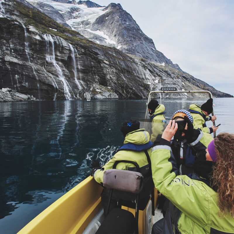 Nuuk Water Taxi stopping at waterfall. Photo - Peter Lindstrom , Visit Greenland