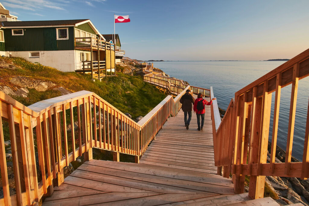 A couple taking a walk on the path along the coastline of Nuuk. Photo by Peter Lindstrom - Visit Greenland