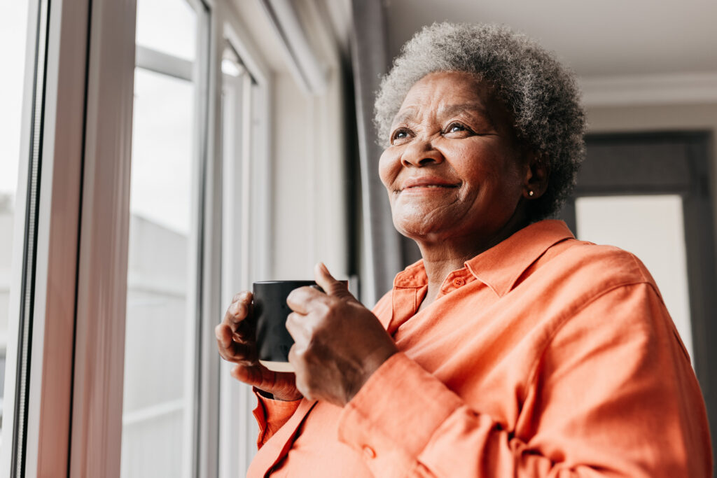 Senior woman enjoying coffee in a senior living community at Vista Prairie Garnette Gardens, Redwood Falls, MN.