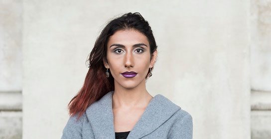 Carefully styled transgender woman with confident expression, promoting gender-affirming healthcare services.