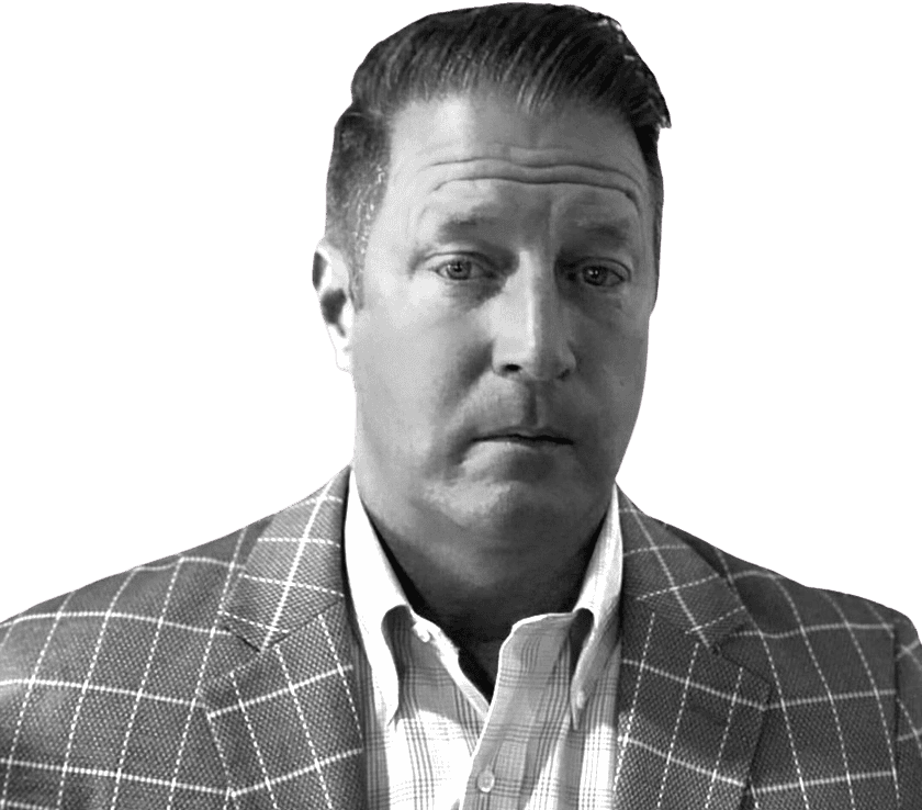 Black and white portrait of a man in a checkered suit for About Us page.