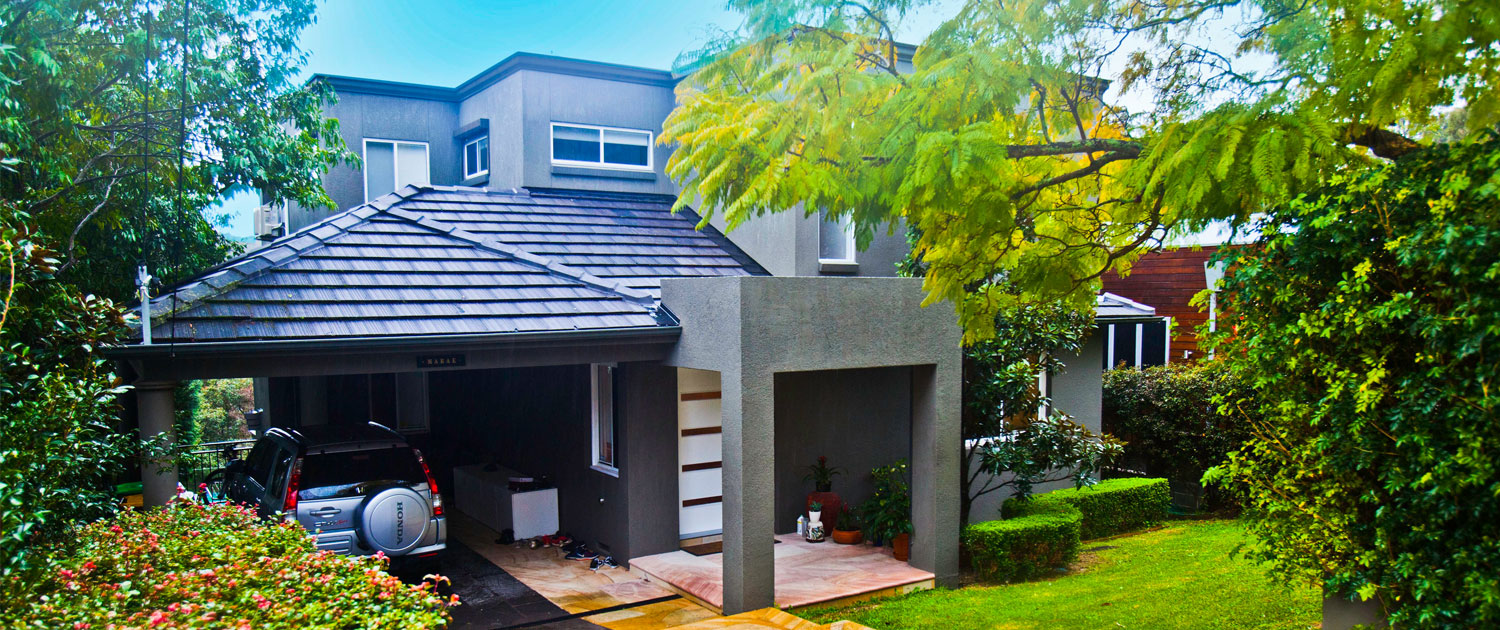 Modern Sydney home exterior with driveway and greenery.