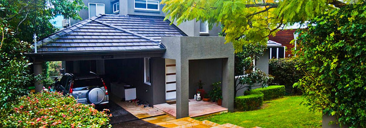 Contemporary residential house in Sydney with lush garden and paved driveway.