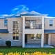 Modern Sydney home with balcony, large windows, and garage.