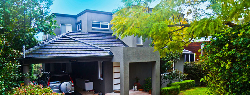 Exterior view of a contemporary Sydney residential house with a well-maintained garden and driveway.