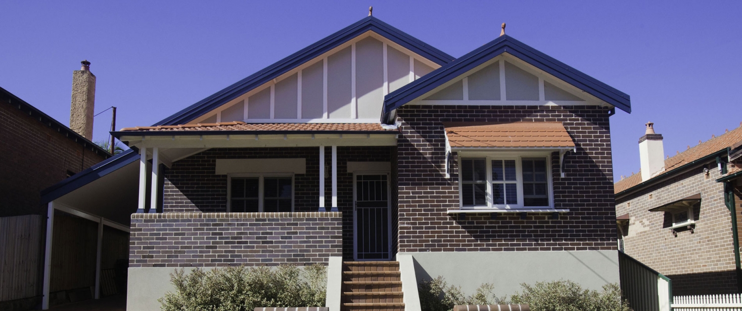 Exterior view of a renovated Sydney residential house with brick walls and gabled roof.