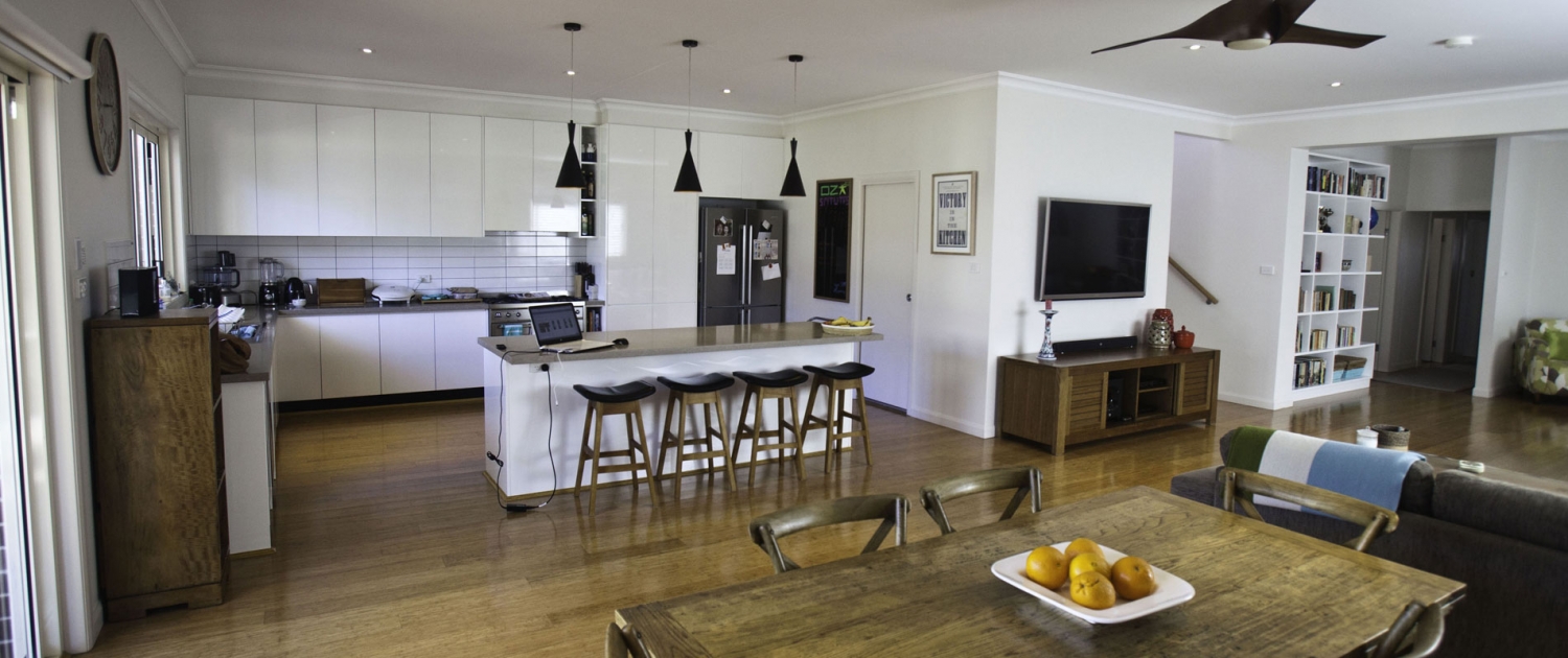 Open-plan kitchen and living space with modern appliances and stylish decor in Sydney home.