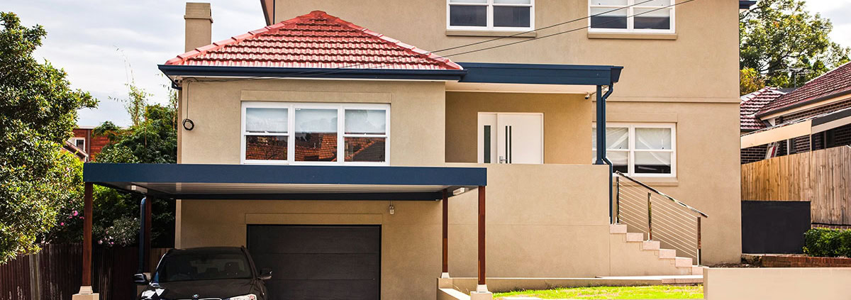 Contemporary two-storey residential house in Sydney with garage, front steps, and landscaped yard.