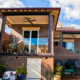 Outdoor balcony with brick walls, ceiling fan, and patio furniture in a Sydney home.