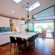 Bright, airy interior featuring white cabinetry, wooden flooring, and contemporary lighting fixtures.