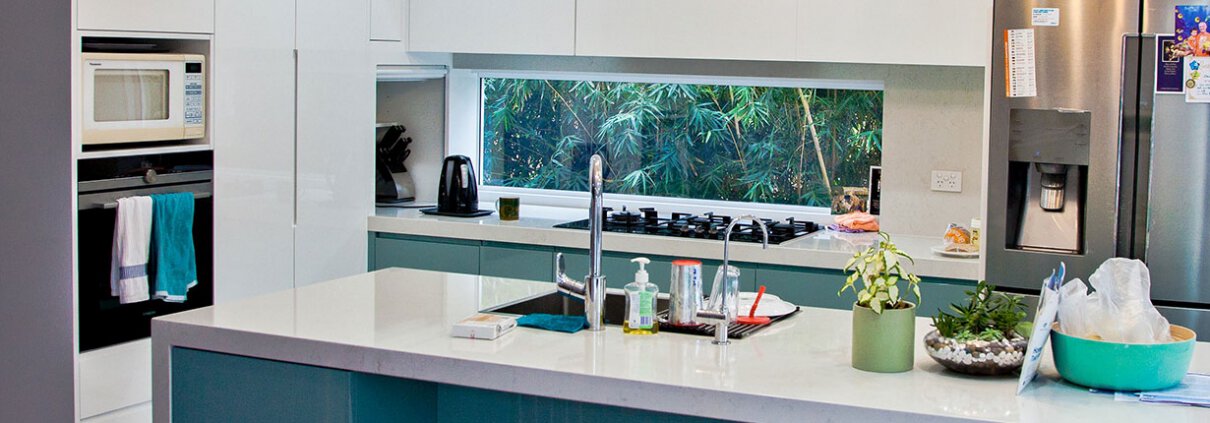 Contemporary kitchen interior with white cabinets, a central island, and modern appliances in a Sydn.