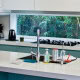 Contemporary kitchen interior with white cabinets, a central island, and modern appliances in a Sydn.