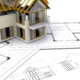 New residential building in Sydney with wooden framing and architectural plans.