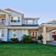 A spacious two-story Sydney home featuring a well-maintained lawn, front porch, and contemporary ext.