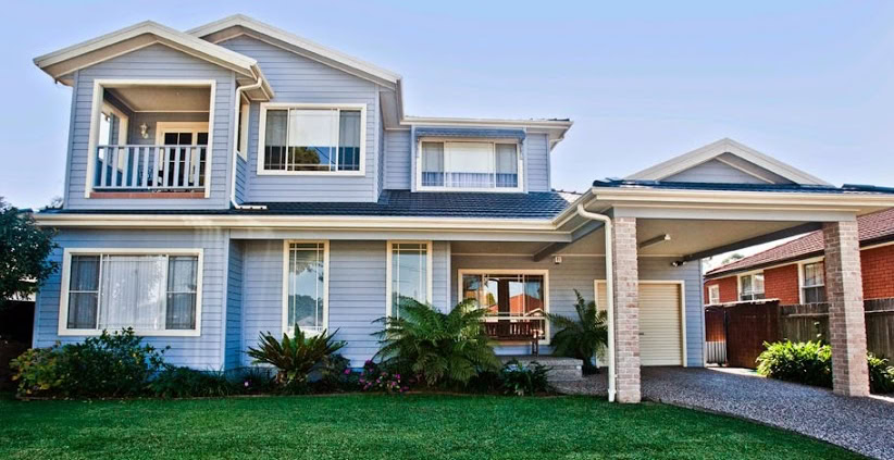A spacious two-story Sydney home featuring a well-maintained lawn, front porch, and contemporary ext.