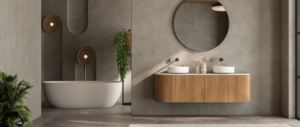 Contemporary bathroom featuring a bathtub, wooden vanity, round mirror, and minimalist decor.