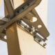 Close-up of wooden construction with metal bolts and brackets.