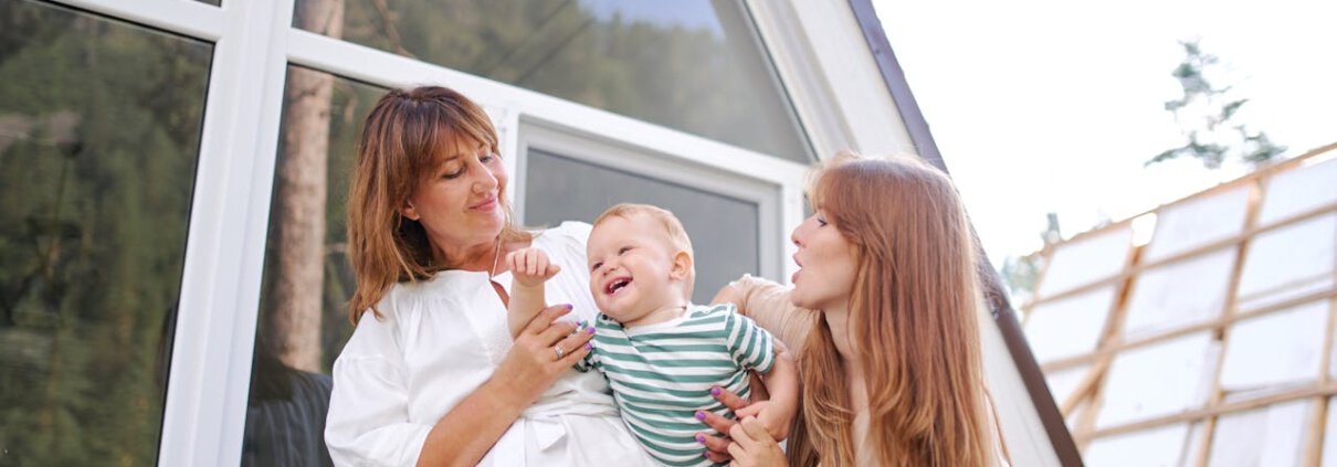 Family enjoying quality time in a modern, sunlit home with large windows.
