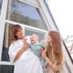 Family enjoying quality time in a modern, sunlit home with large windows.