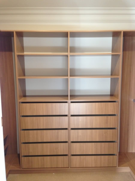 Custom wooden wardrobe with multiple drawers and shelves in Sydney.