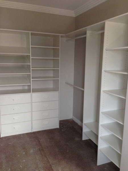 Custom walk-in wardrobe storage solutions in Sydney by Waratah Wardrobes, featuring white shelving a.