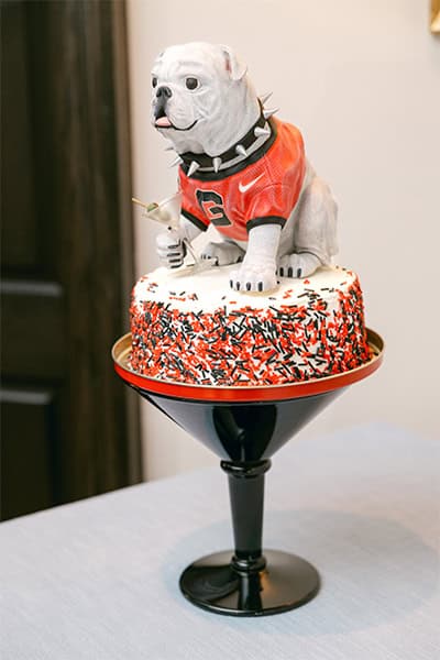 Dog cake with football jersey topper, perfect for wedding celebrations.