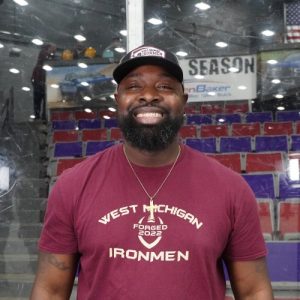 Coach Terry Mitchell at West Michigan Ironmen game in arena.