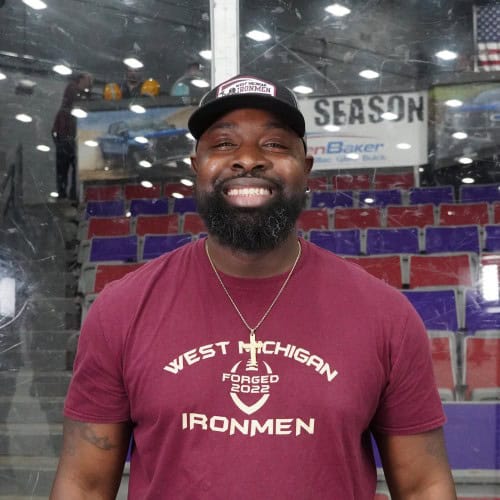 Coach Terry Mitchell at West Michigan Ironmen game in arena.