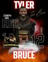 Tyler Bruce, West Michigan Ironmen football player, smiling in team gear.