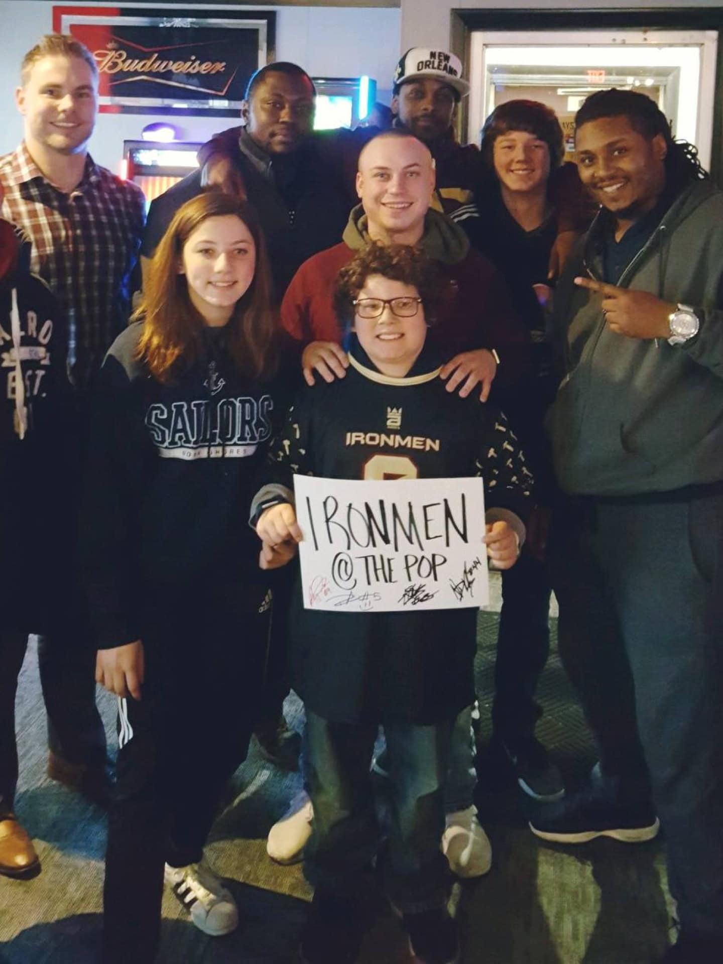 Group of diverse fans and players at West Michigan Ironmen game.