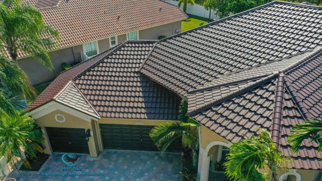 Top Hurricane Roofing Tips To Prepare For The Storm Season In South Florida 1 Aerial view of a house with brown tile roofing, ready for storm season through Whale Roofing's hurricane roofing tips.