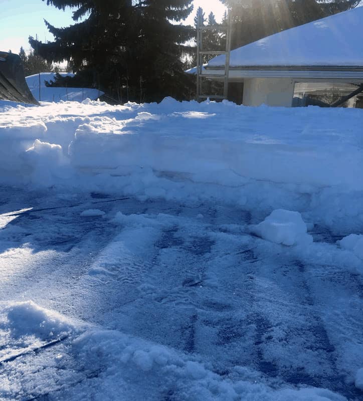 Wooden Home Frame A flat roof with snow being removed