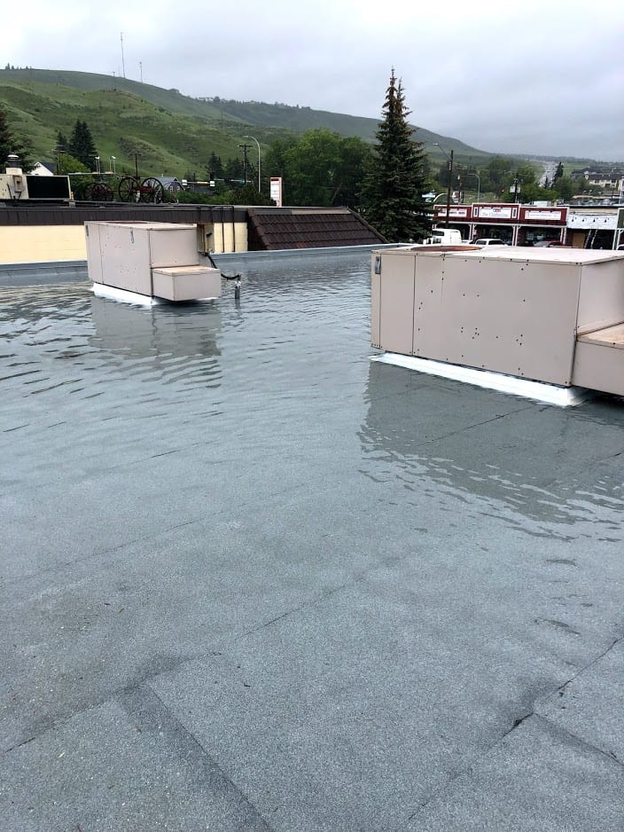 Darinage Roof in chocrane that flooded from improper drainage