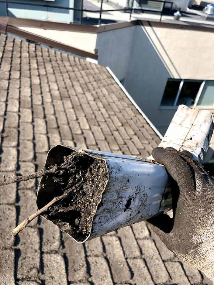 gutterblockagedownspout Roof in NE Calgary showing storm damage from a hail storm.