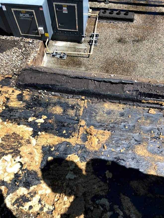 6C5B3B73-9AB7-4D68-84F2-FE11305EA5F2 Calgary downtown roof inspection showing water damage on a flat roof