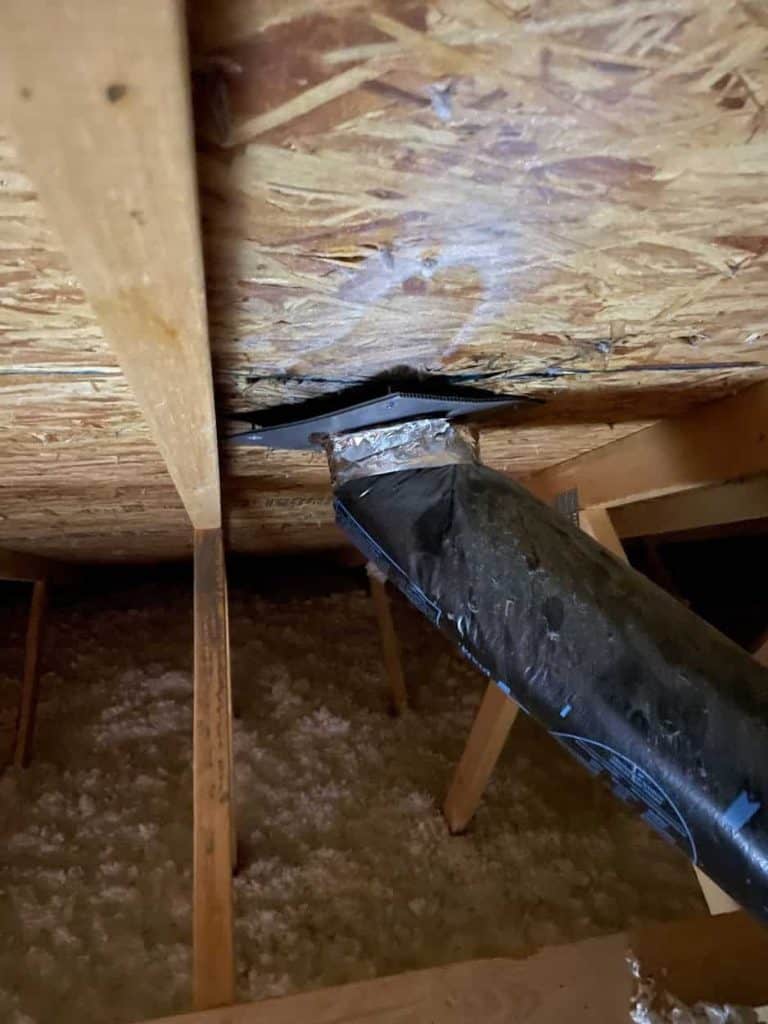 A steam vent that's open and venting into the attic