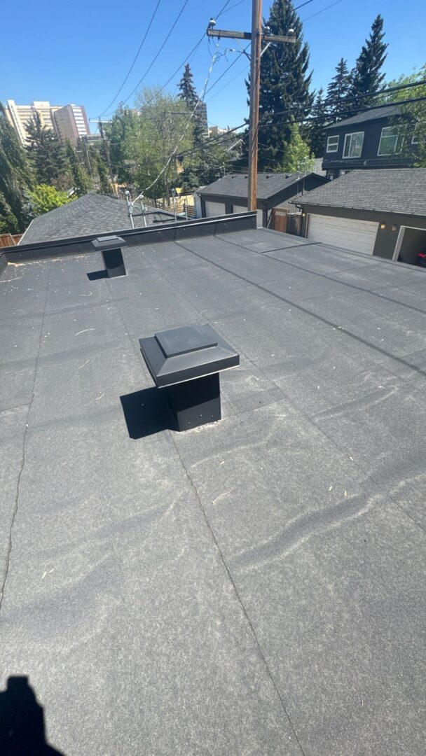 Torch-on flat roof with visible bubbling caused by insufficient heat during installation, increasing the risk of popped seams and future leaks.