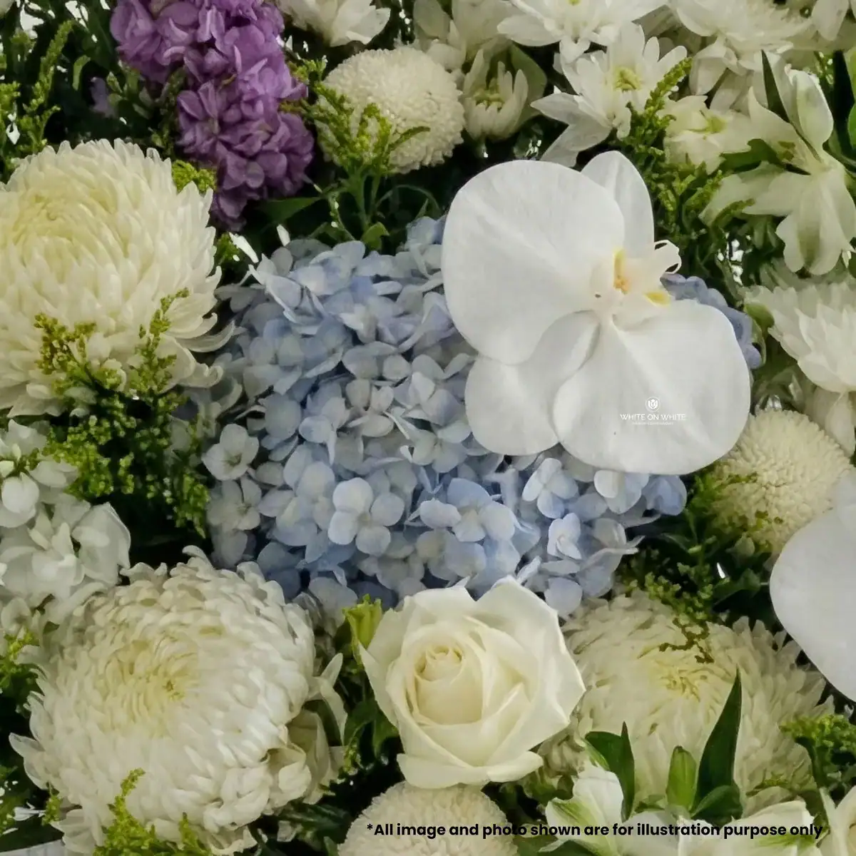Grand funeral flower stand featuring Purple Matthiola and Blue Hydrangea with White Orchids by White On White