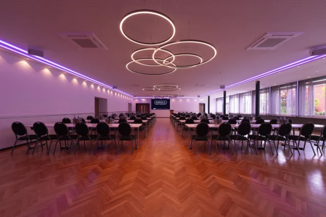 Conference room with row seating, screen and panoramic windows
