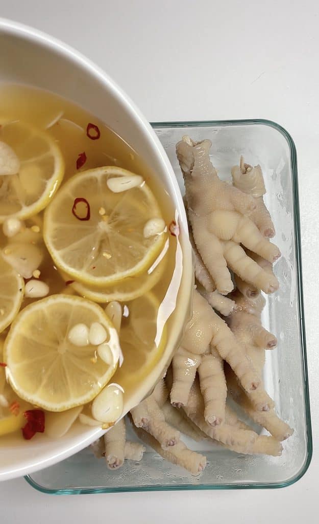pouring marinate to chicken feet