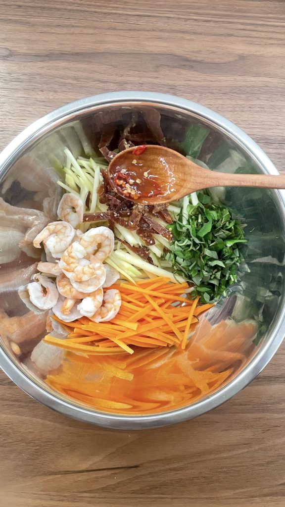 Pouring sauce to the salad