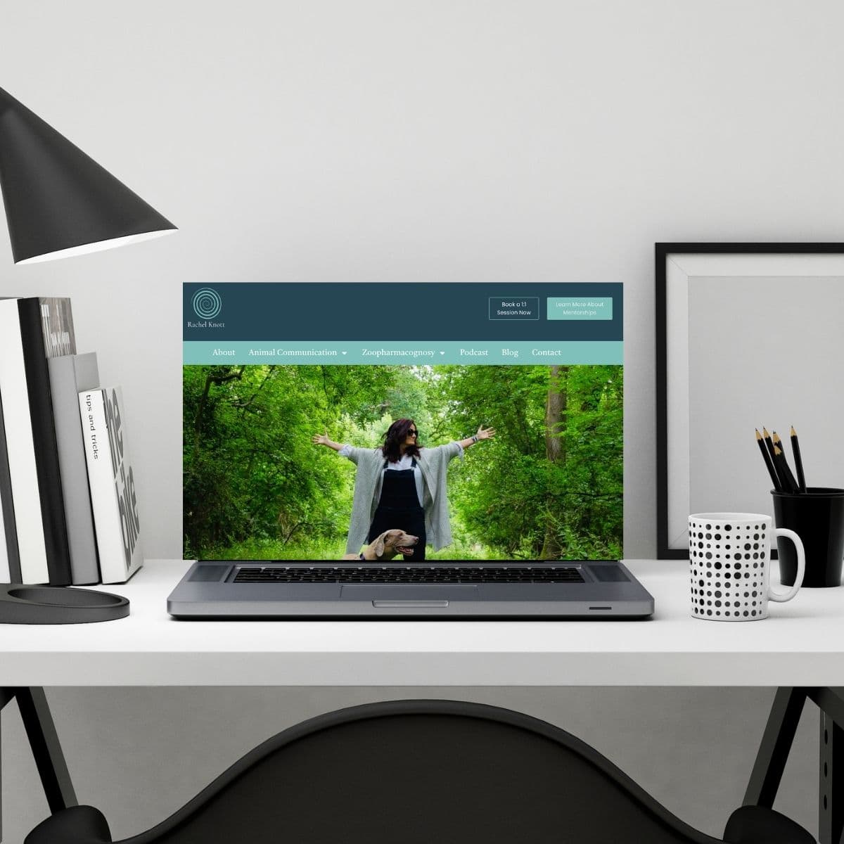 A lush green forest scene with a woman standing with arms outstretched on a laptop screen.