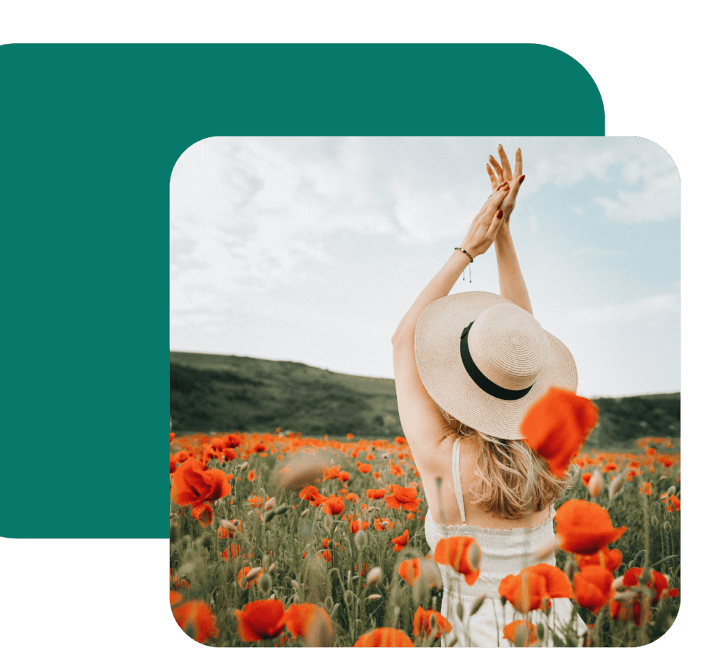 Woman walks through fields of poppies with hands over her head