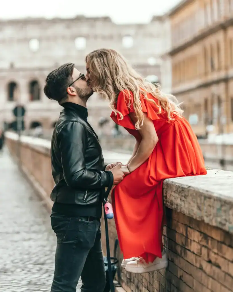 a couple kisses in the street as the woman in the relationship is in her ovulatory phase