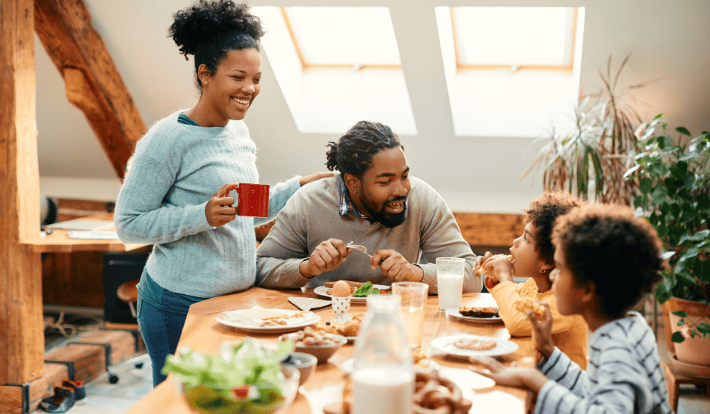 Happy family having breakfast together in a cozy, sunlit kitchen.