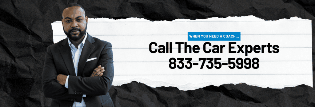 Dominic Scruggs, suited, stands by a torn paper ad: “Need auto advice? Call The Car Experts 833-735-5998.” Black and white.